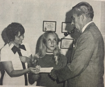 Kathy Knowles accepting a scholarship from president Don White