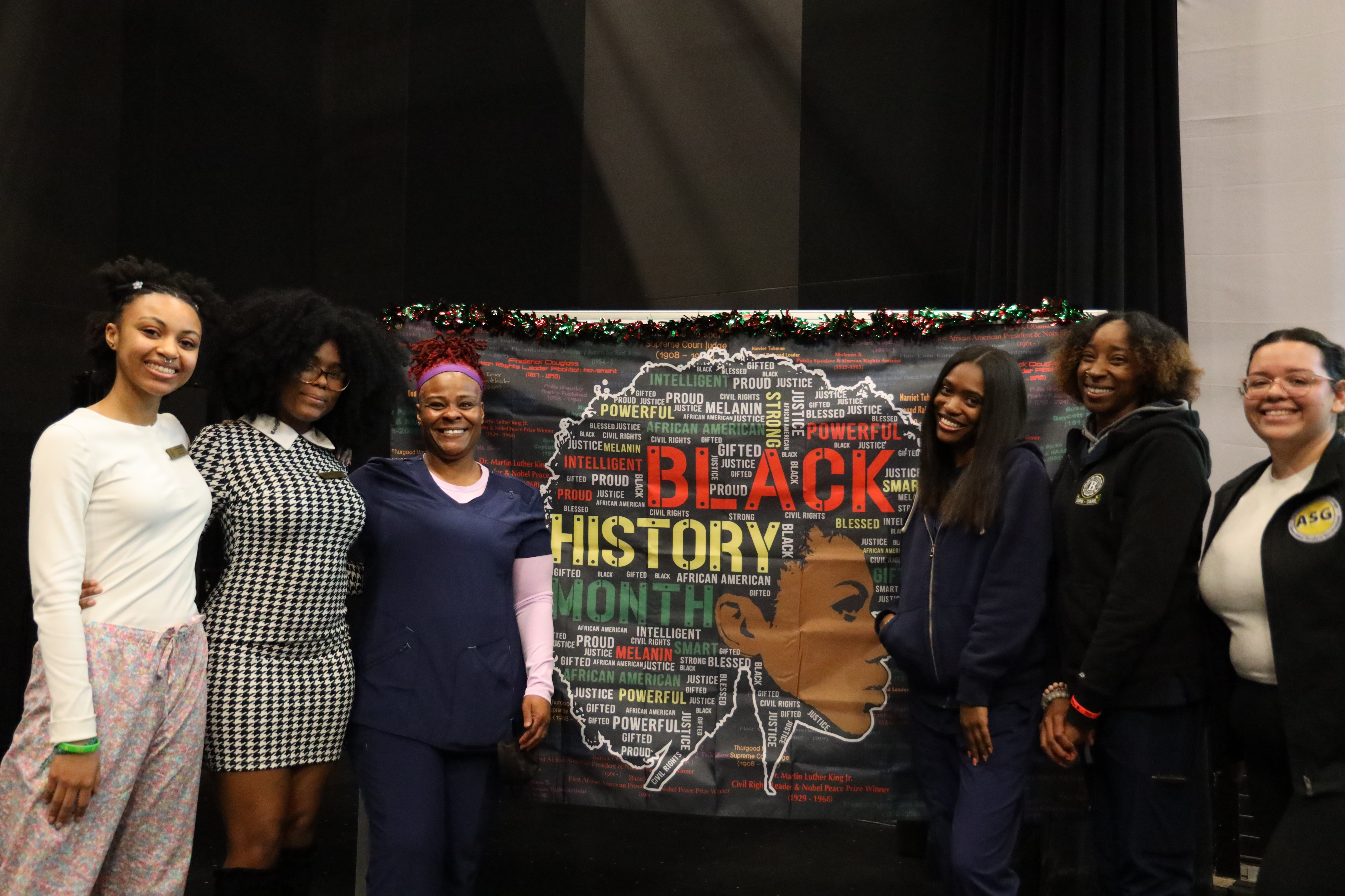students in front of Black History Month backdrop