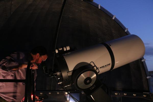 Professor looking through the telescope