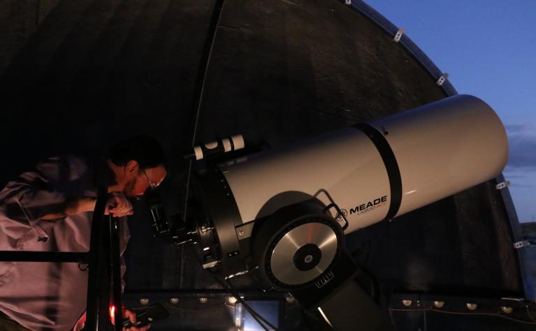 Professor looking through the telescope