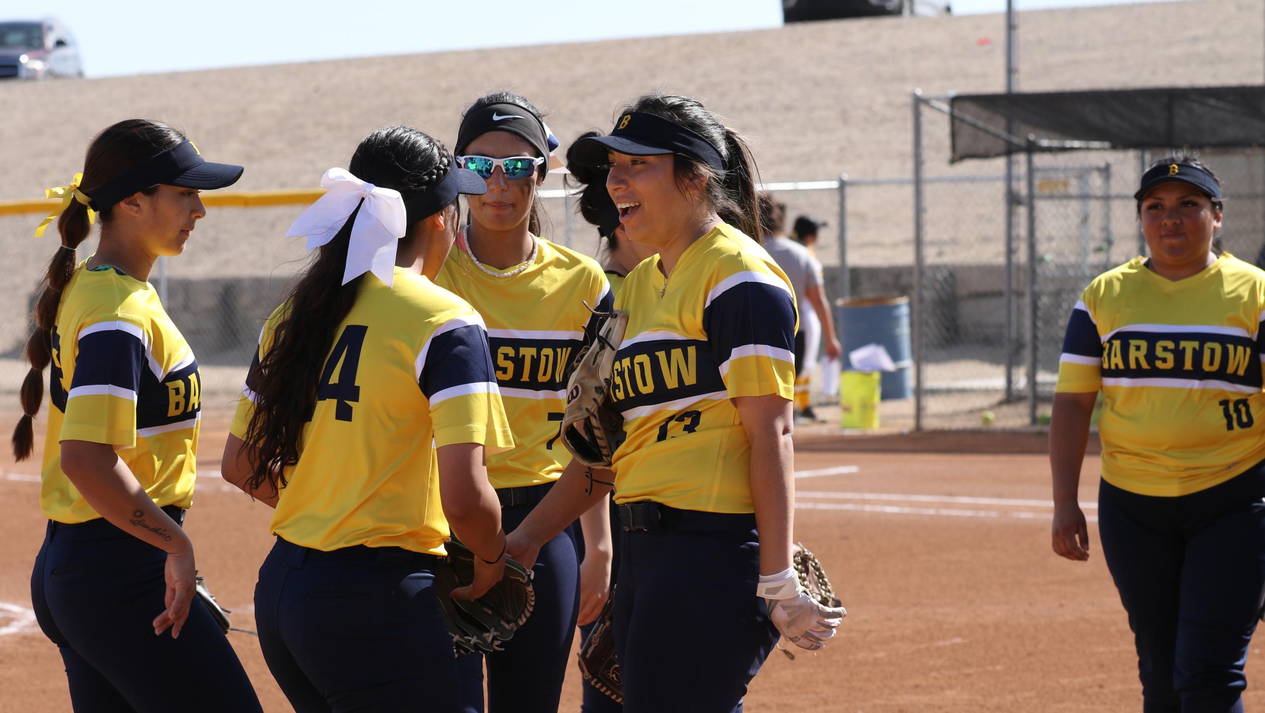 Softball players in a huddle